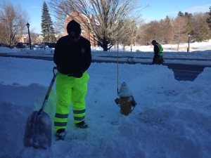 UConn Fire Lieutenant Scott McDonald finishes digging out a fire hydrant with his colleague. (Photo by Sylvia Cunningham/WHUS News)