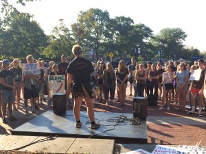 A student at the University of Connecticut tells the crowd at SlutWalk 2015 her story.