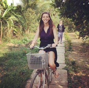 Julia Brzezinska riding a bike during a visit in Vietnam. Photo Credit: Julia Brzezinska